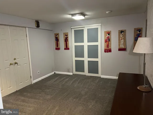 a view of an empty room with a cabinet