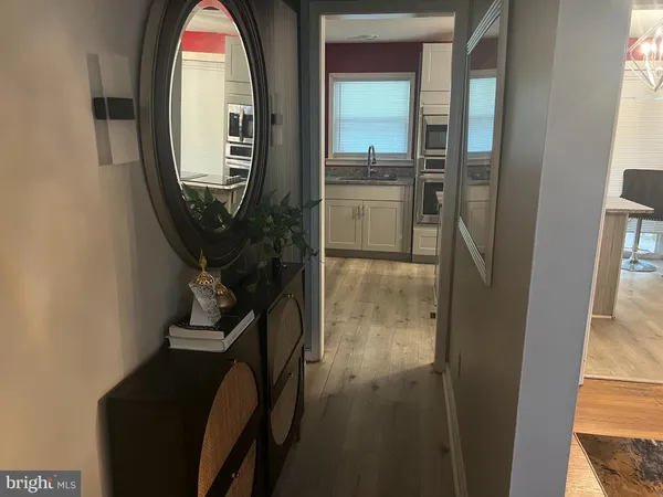 a view of a livingroom with furniture and a mirror