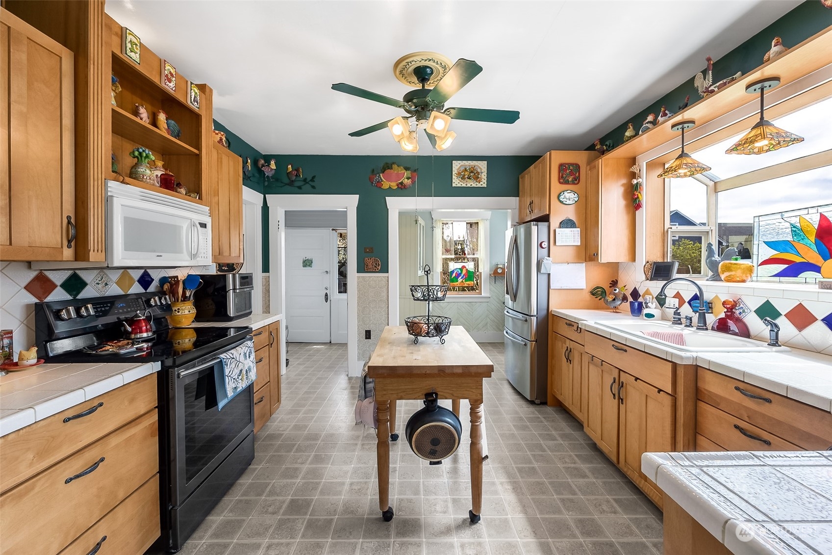 222 Wells Avenue North Renton, WA 98057 - Photo 11 of 23 a kitchen with stainless steel appliances granite countertop a sink dishwasher a stove and a refrigerator