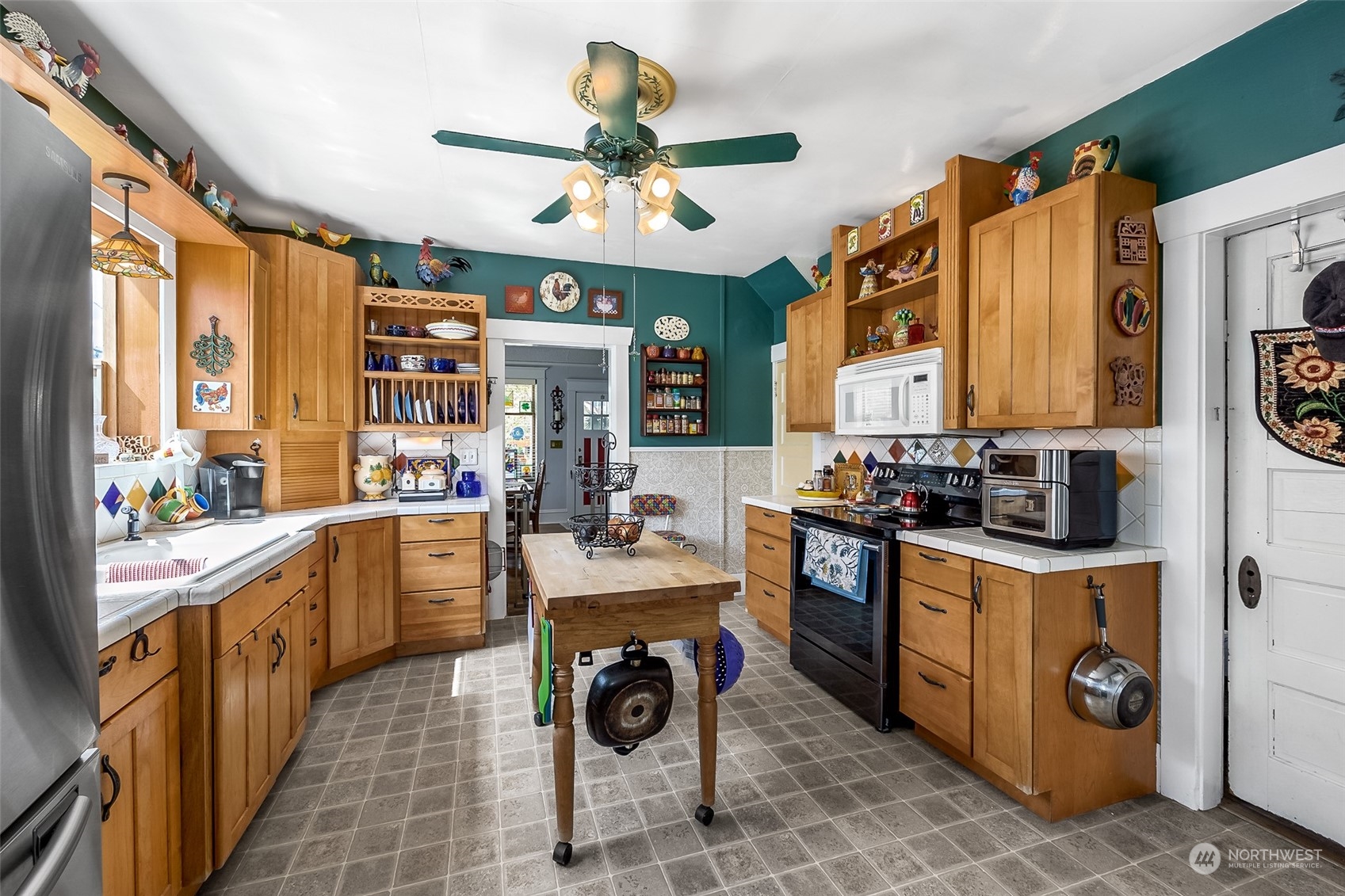 222 Wells Avenue North Renton, WA 98057 - Photo 13 of 23 a kitchen with a stove a sink and a refrigerator