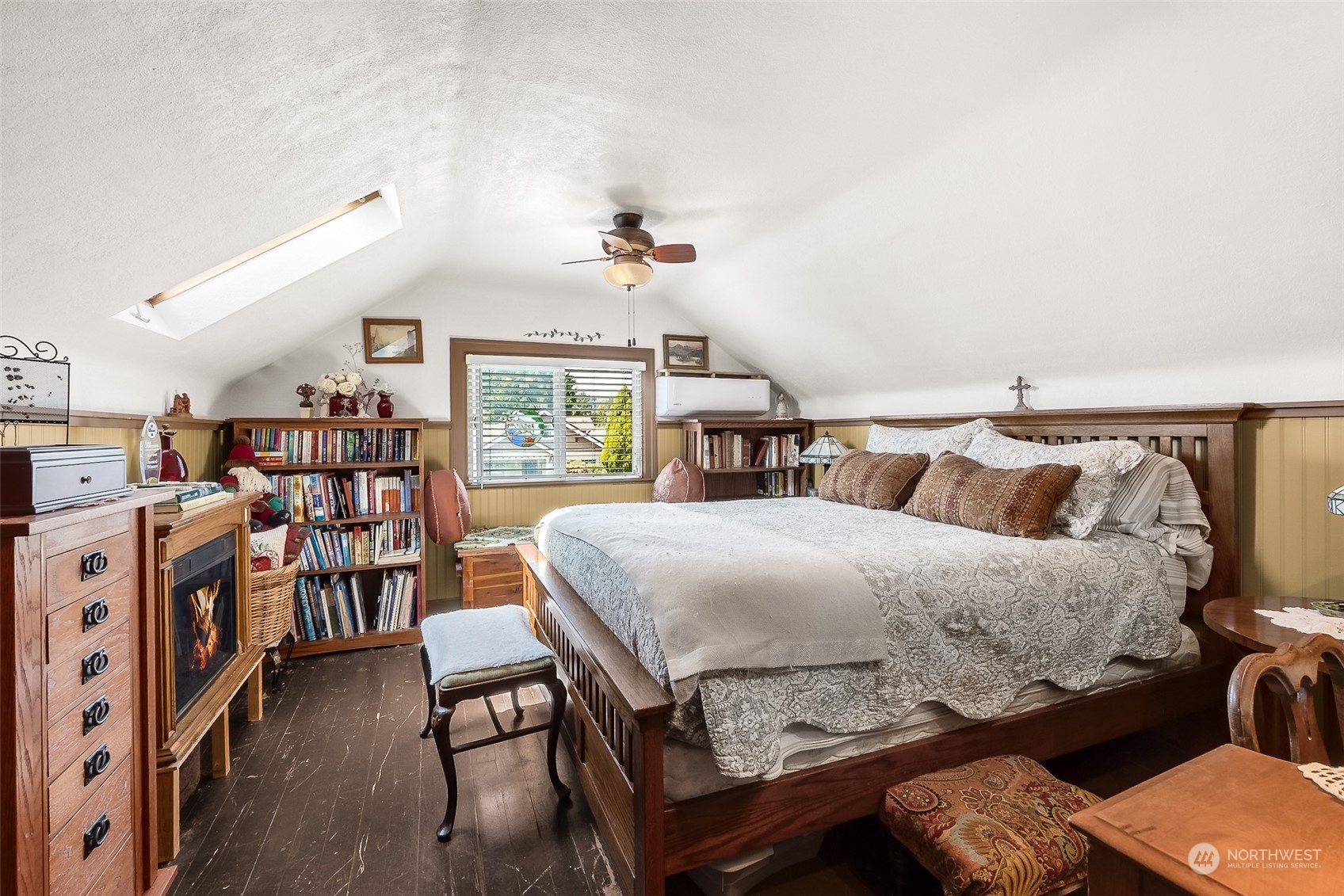 222 Wells Avenue North Renton, WA 98057 - Photo 23 of 23 a bedroom with a bed and a bookshelf with wooden floor