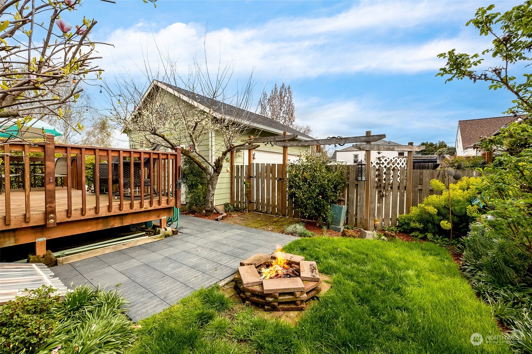 222 Wells Avenue North Renton, WA 98057 - Photo 5 of 23 a garden with trees in front of it