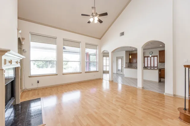 a view of empty room with wooden floor and fireplace