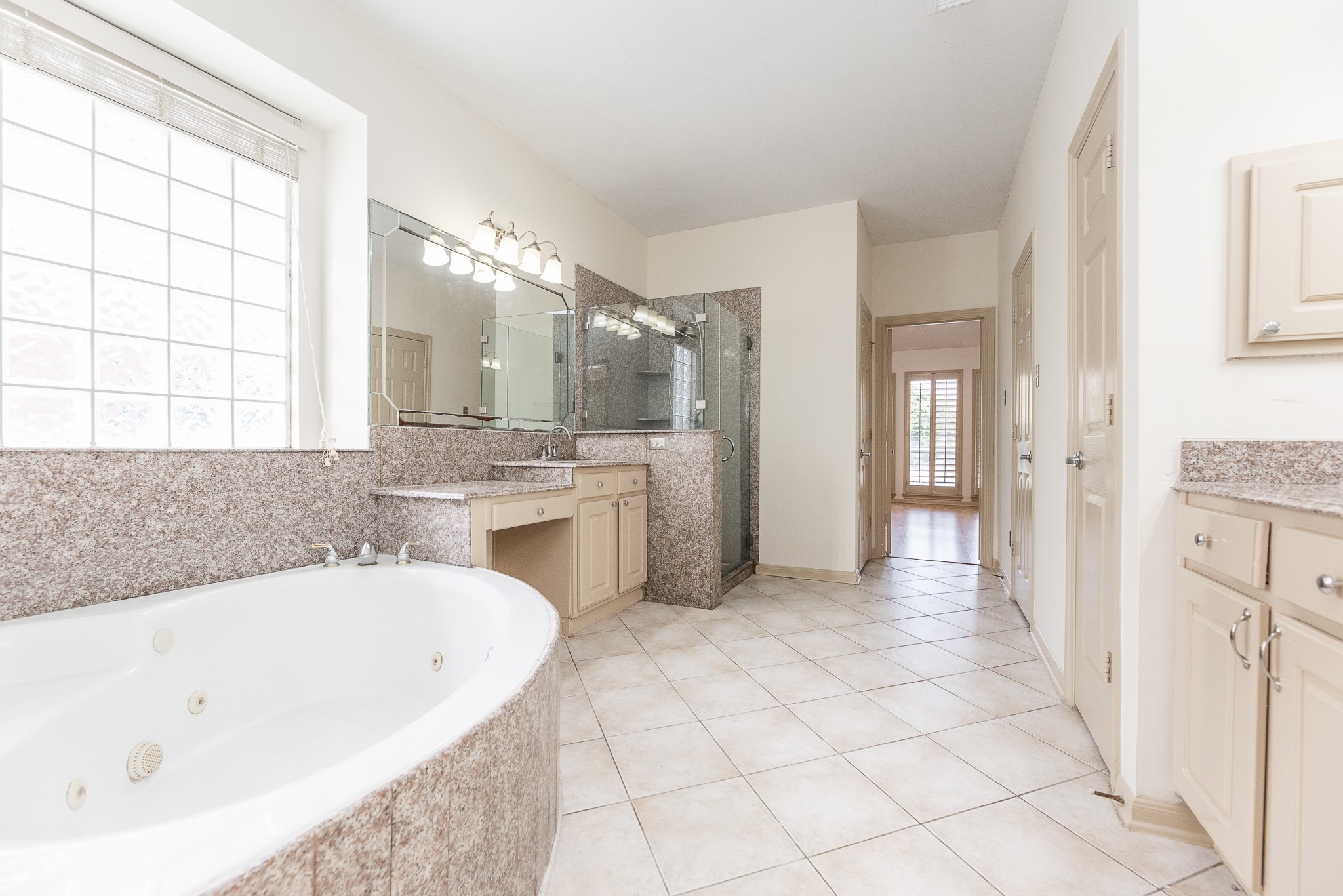 17826 Island Spring Lane Tomball, TX 77377 - Photo 29 of 47 a spacious bathroom with a tub sink and mirror