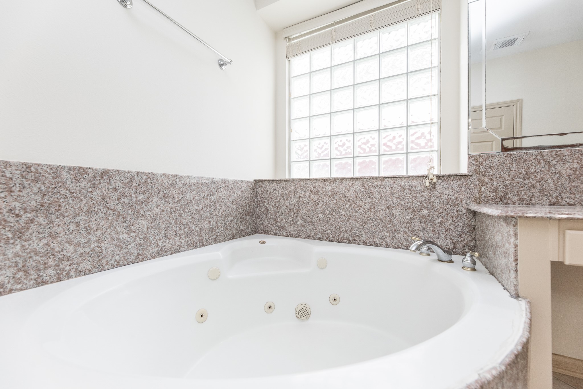 17826 Island Spring Lane Tomball, TX 77377 - Photo 30 of 47 a white bath tub sitting in a bathroom next to a window