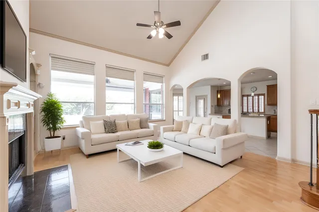 a living room with fireplace furniture and a large window