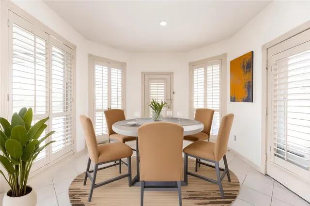 a dining room with furniture and wooden floor