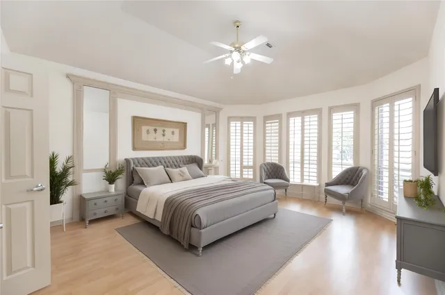 a living room with a bed furniture and a large window