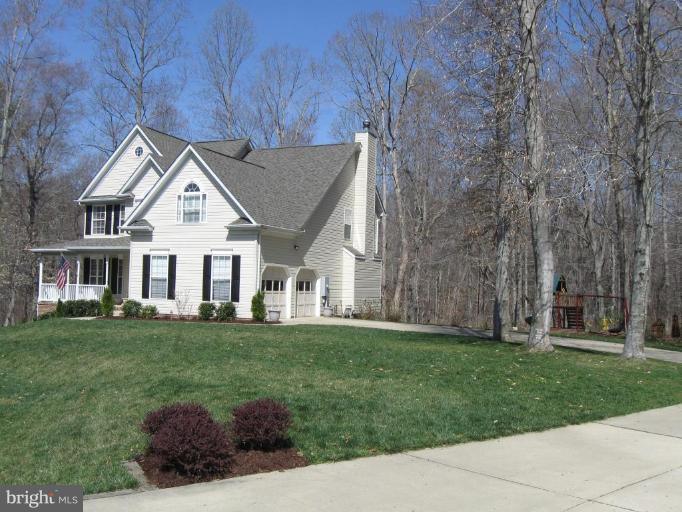 44886 Mallard Place Callaway, MD 20620 - Photo 2 of 30 a front view of a house with a garden