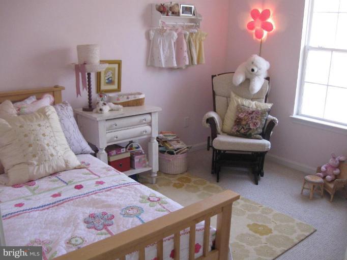 44886 Mallard Place Callaway, MD 20620 - Photo 23 of 30 a bedroom with a bed and a chandelier