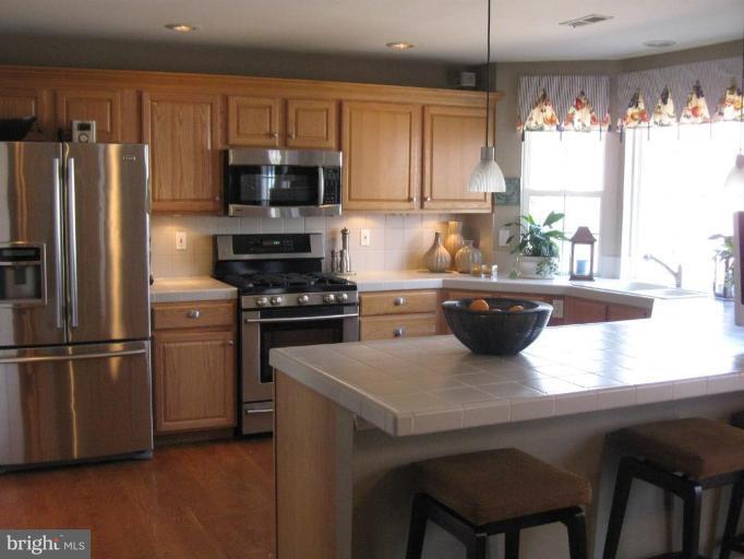 44886 Mallard Place Callaway, MD 20620 - Photo 5 of 30 a kitchen with a refrigerator and a stove top oven