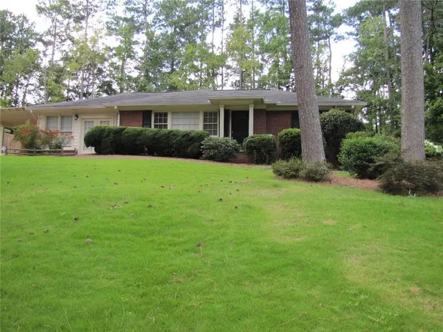 a view of an house with backyard space and garden