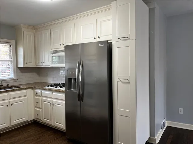 a white refrigerator freezer sitting inside of a kitchen