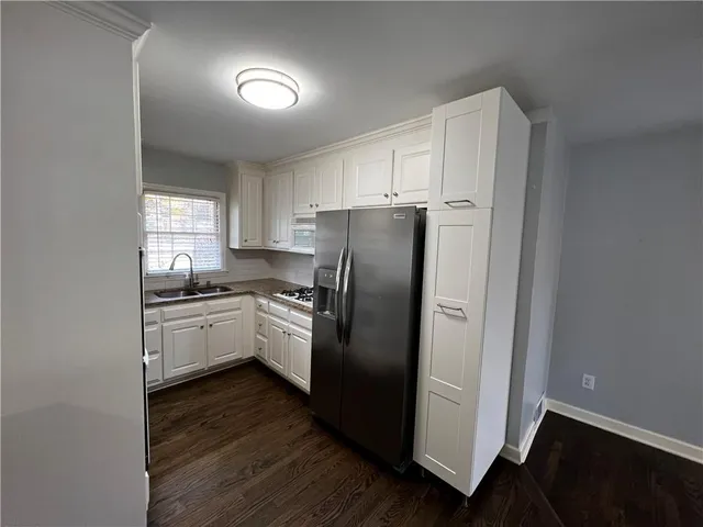a kitchen with stainless steel appliances granite countertop a refrigerator and a stove top oven