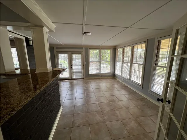 a hallway with a large window and wooden floor
