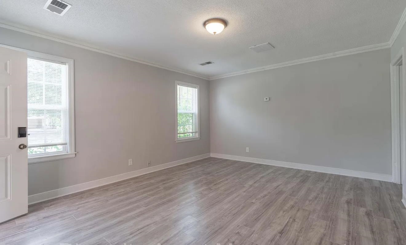 1009 McEvers Road Memphis, TN 38111 - Photo 6 of 6 an empty room with wooden floor and windows