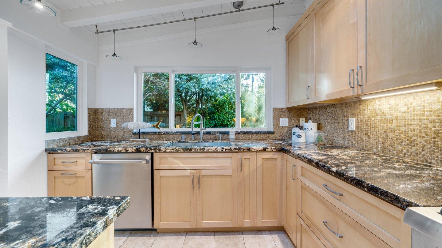 806 Rorke Way Palo Alto, CA 94303 - Photo 22 of 41 a kitchen with kitchen island granite countertop a sink stove and cabinets