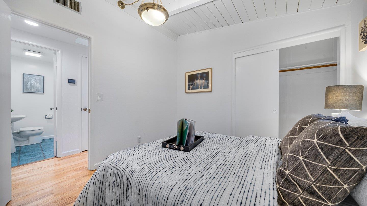 806 Rorke Way Palo Alto, CA 94303 - Photo 26 of 41 a bedroom that has a bed and a chandelier