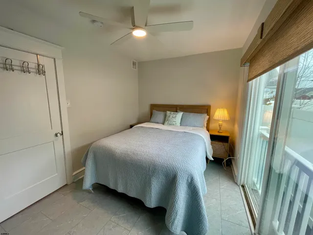 a bedroom with a bed and a mirror