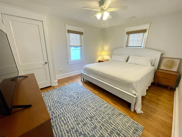 a bedroom with a bed and a flat screen tv