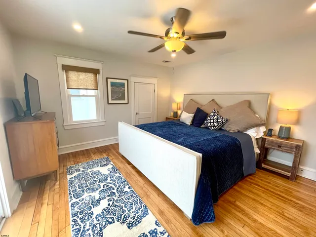 a bed room with a bed and a ceiling fan