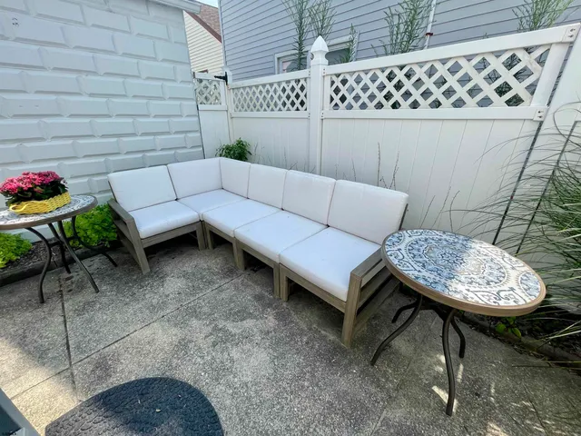 a view of a patio with couches chairs and a potted plant