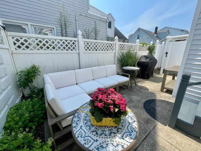 a backyard of a house with table and chairs