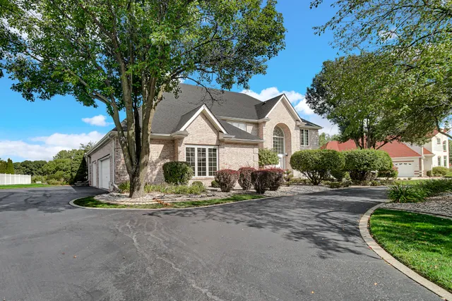 a view of a house with a tree in front of it