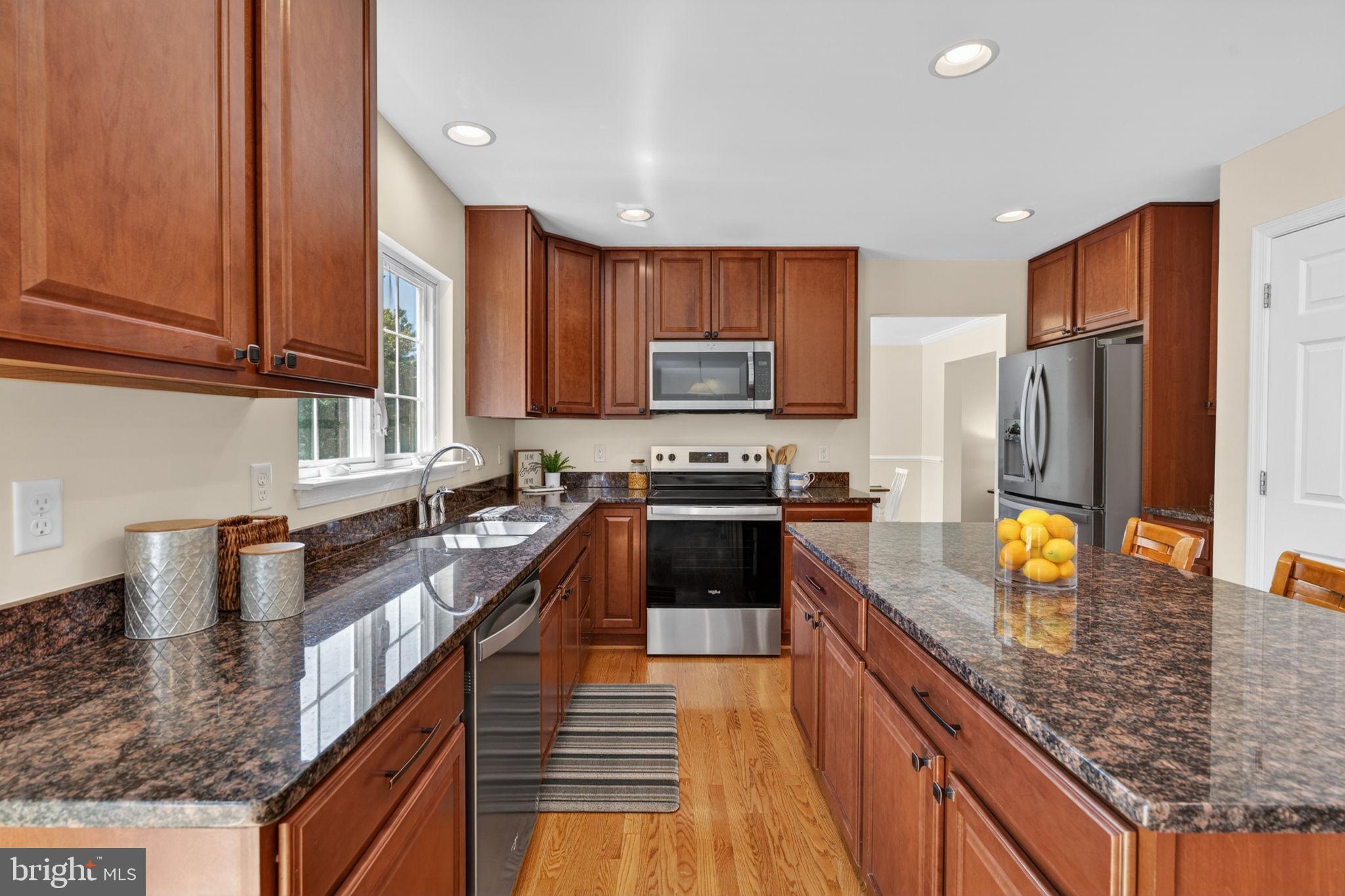 6090 Old Washington Road Elkridge, MD 21075 - Photo 14 of 86 Modern kitchen with rich wood accents.