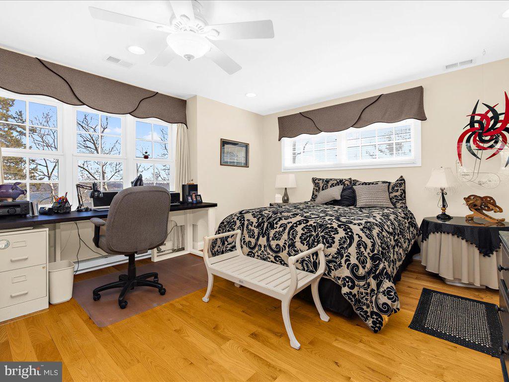 1735 Broadlee Trail Annapolis, MD 21401 - Photo 25 of 65 a bedroom with a bed and a chandelier