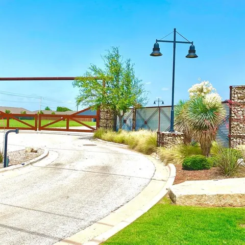 a view of a swimming pool with a lawn chairs under an umbrella