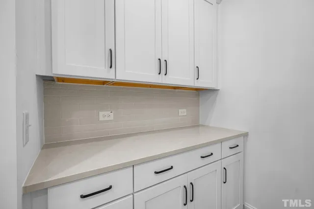 a kitchen with sink microwave and refrigerator