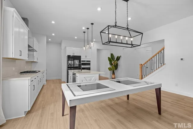 a living room with furniture and a dining table with rug