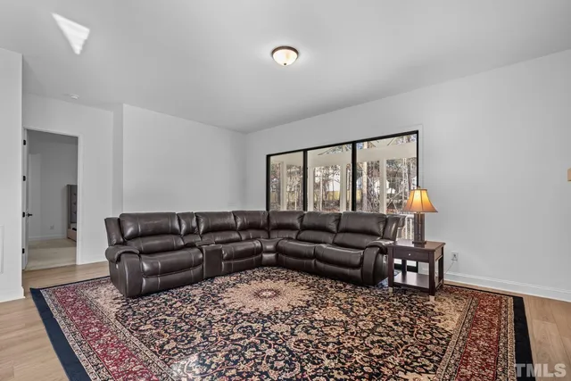 a stone fireplace with a clock on wall