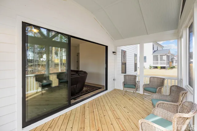 a view of a workspace with furniture and wooden floor