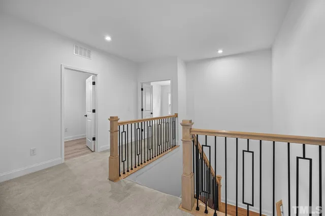 a bed sitting in a bedroom next to a window and a dresser