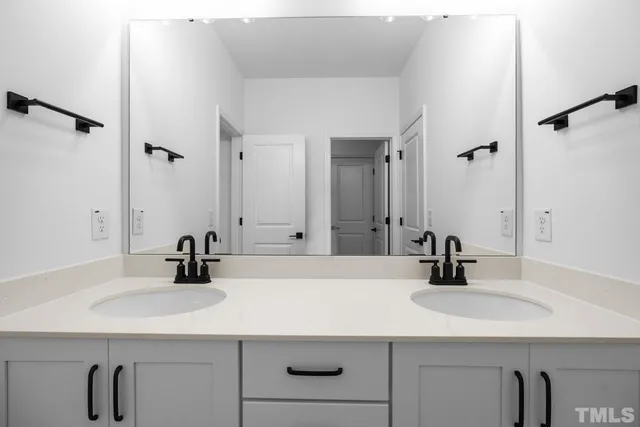 a bedroom with a bed and a lamp