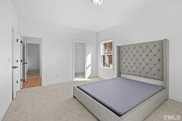 a bathroom with a sink a toilet a mirror a vanity and shower