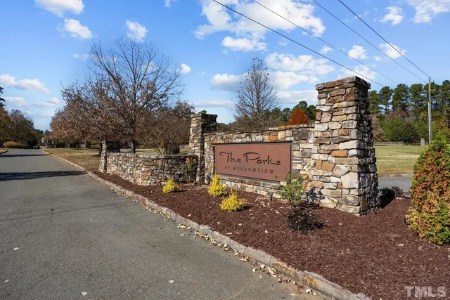 a kitchen with kitchen island stainless steel appliances a sink a counter space and wooden floor