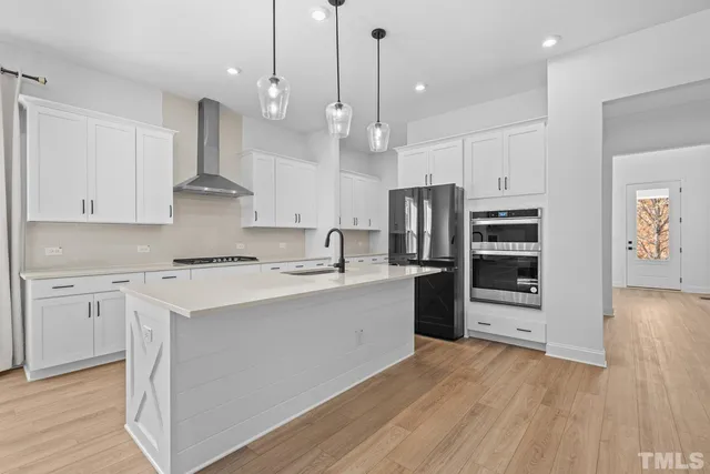 a kitchen that has a sink a microwave a refrigerator and a stove