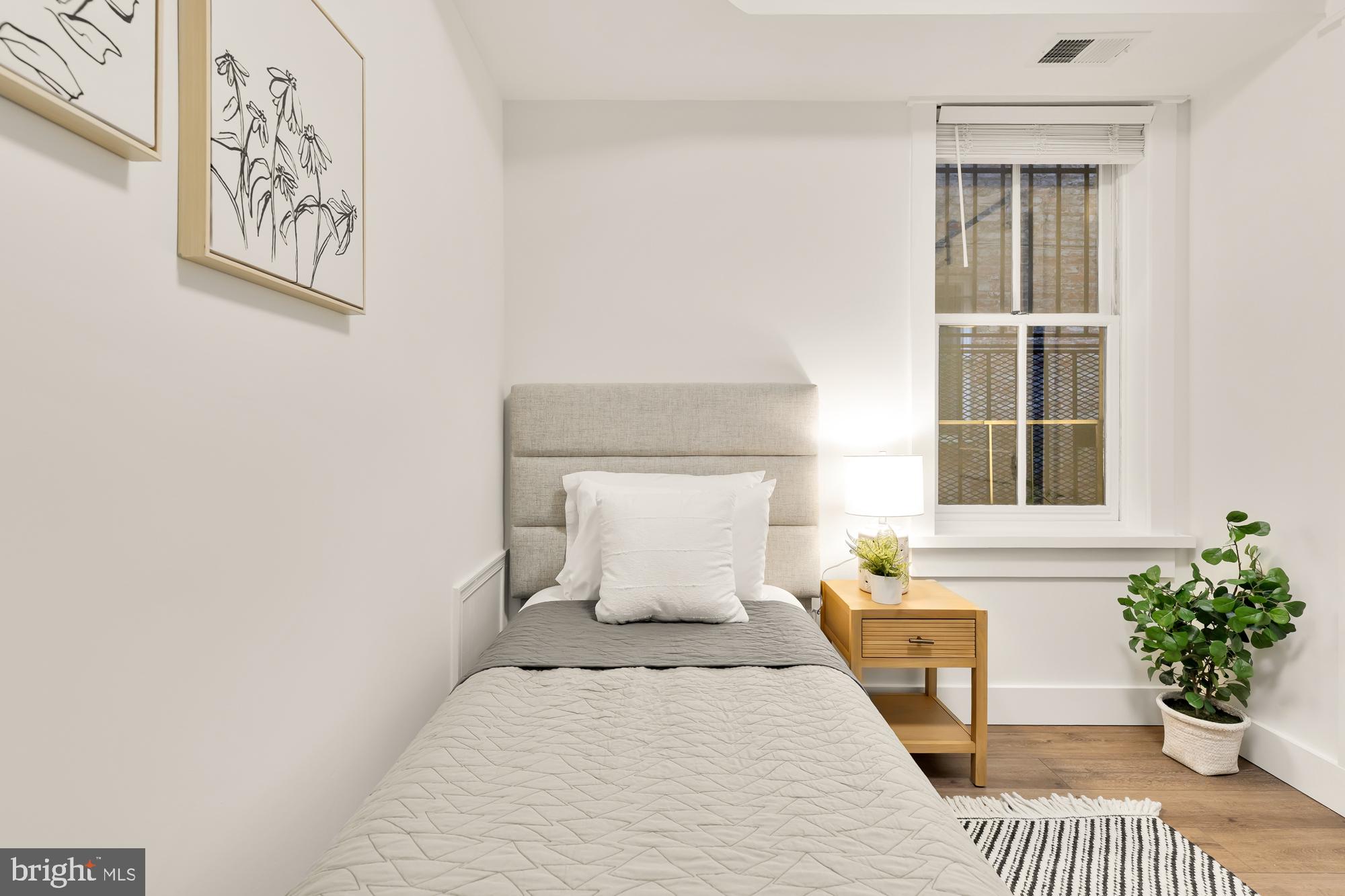 512 U Street Northwest, Unit 3 Washington, DC 20001 - Photo 15 of 26 a bedroom with a bed and a window