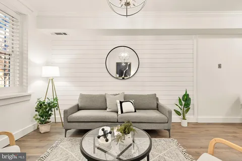 a living room with furniture and a potted plant
