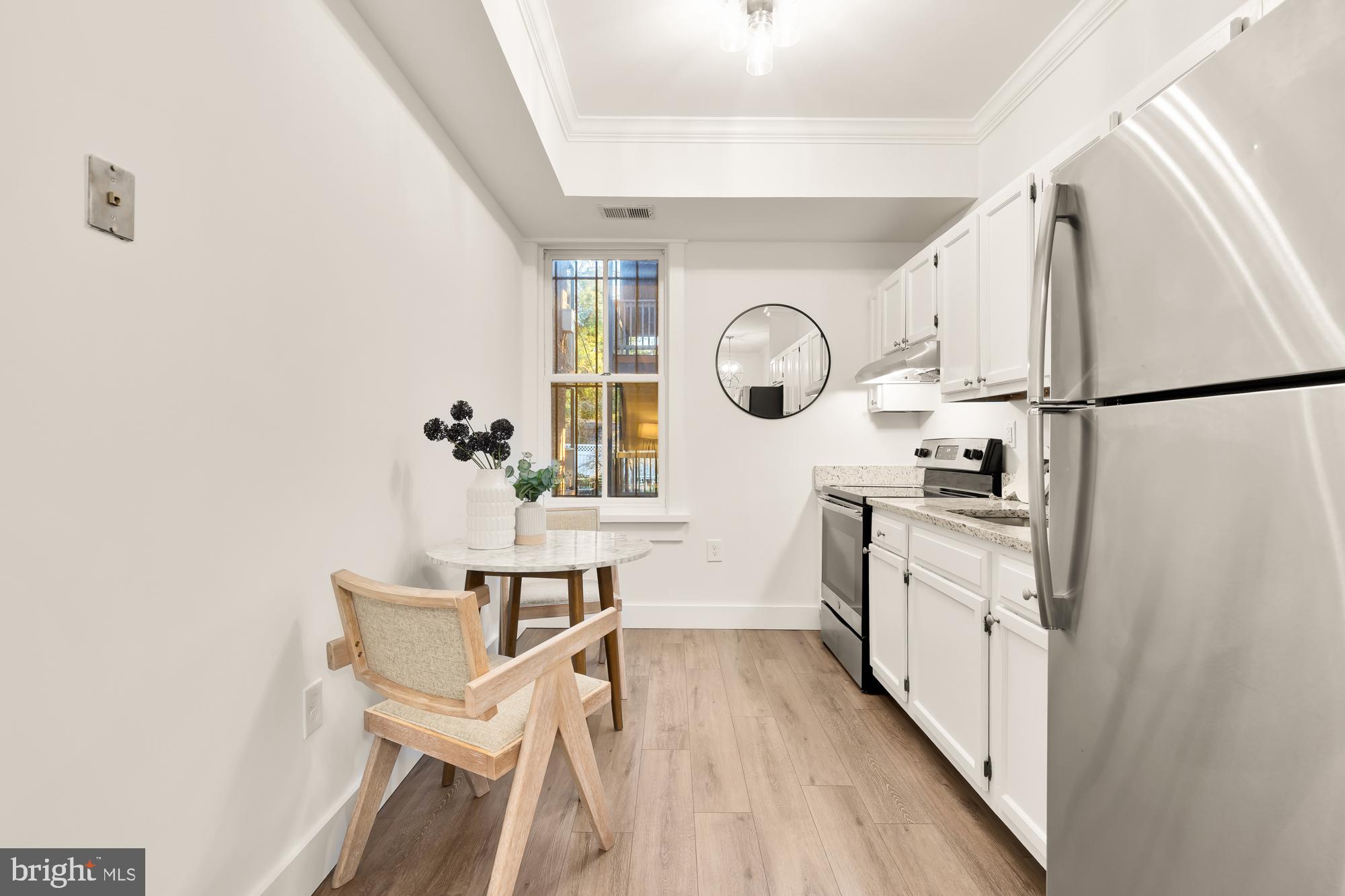512 U Street Northwest, Unit 3 Washington, DC 20001 - Photo 7 of 26 a kitchen with granite countertop white cabinets and white appliances