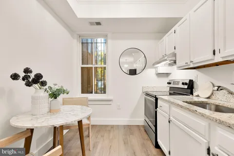 a kitchen with appliances cabinets and furniture