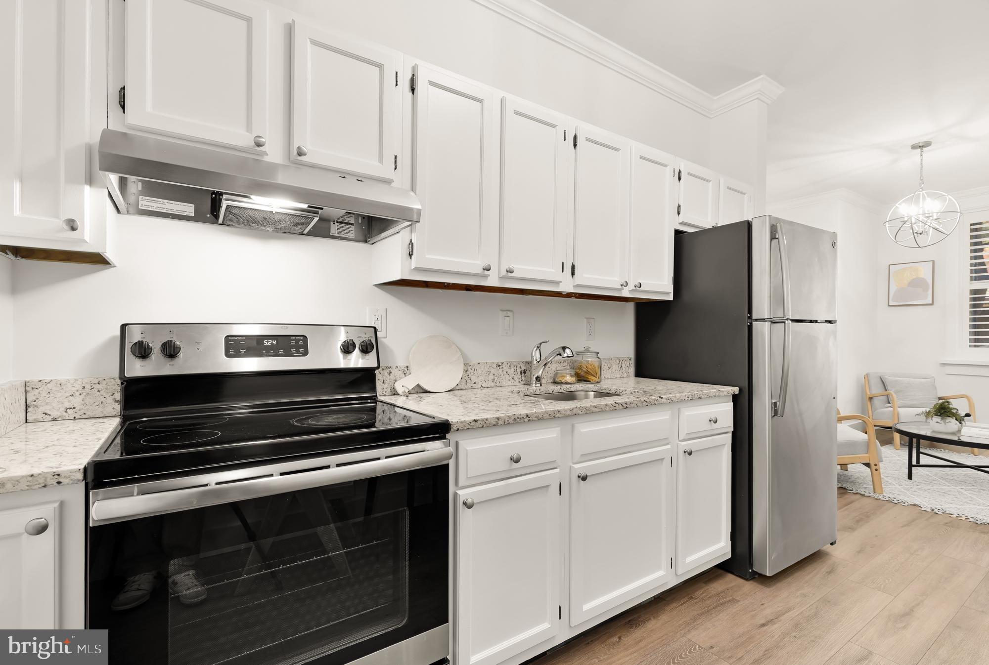 512 U Street Northwest, Unit 3 Washington, DC 20001 - Photo 9 of 26 a kitchen with cabinets appliances and a wooden floor