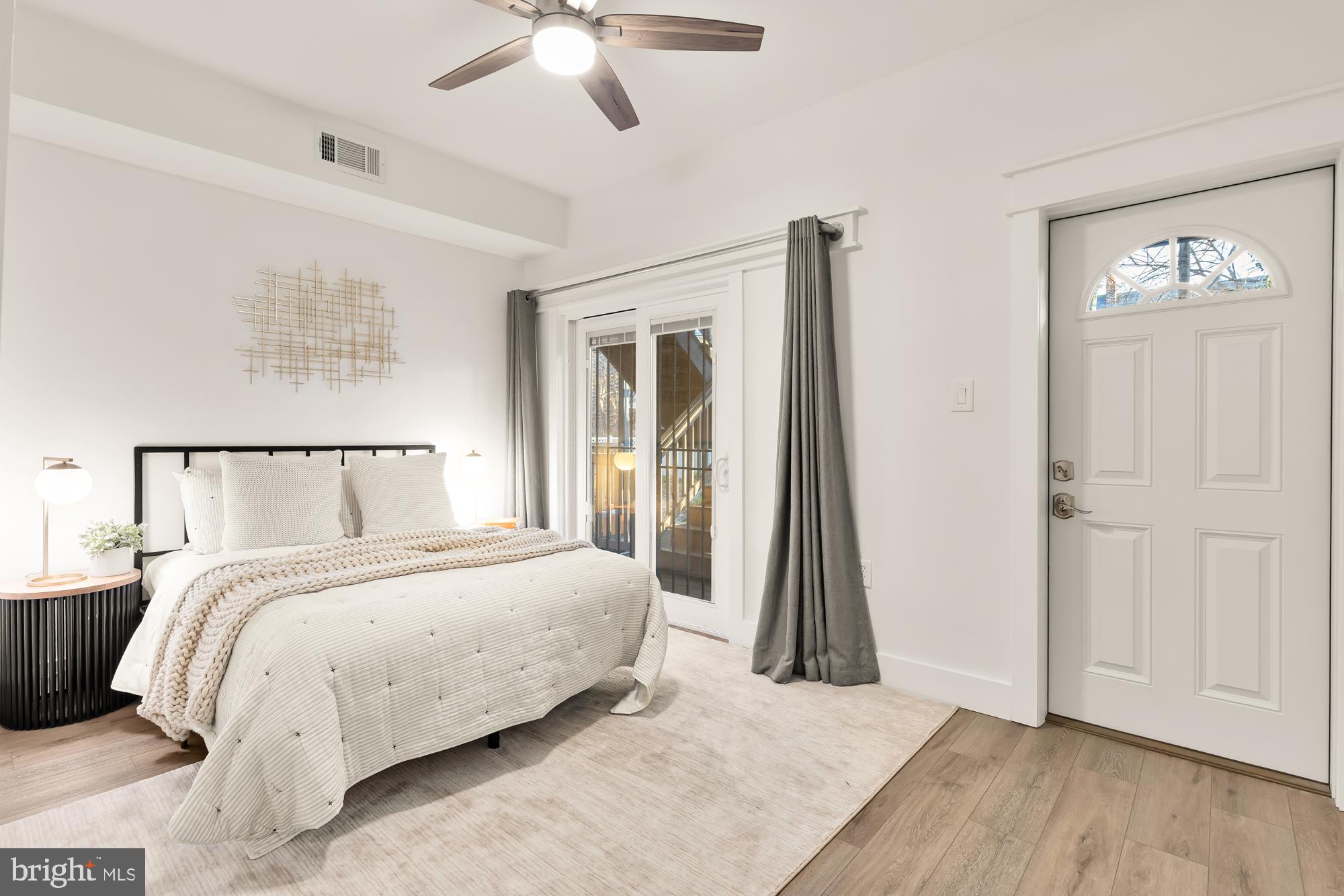 512 U Street Northwest, Unit 3 Washington, DC 20001 - Photo 10 of 26 a bedroom with a bed and a chandelier