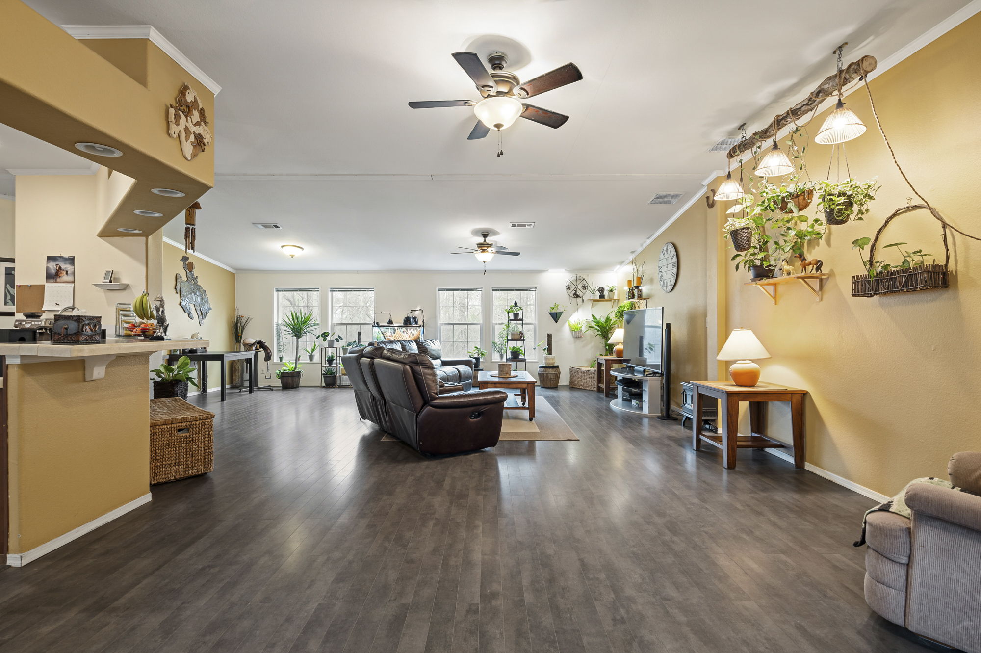 175 Fawn Ridge Road Cedar Creek, TX 78612 - Photo 16 of 34 a living room with furniture kitchen view and a wooden floor