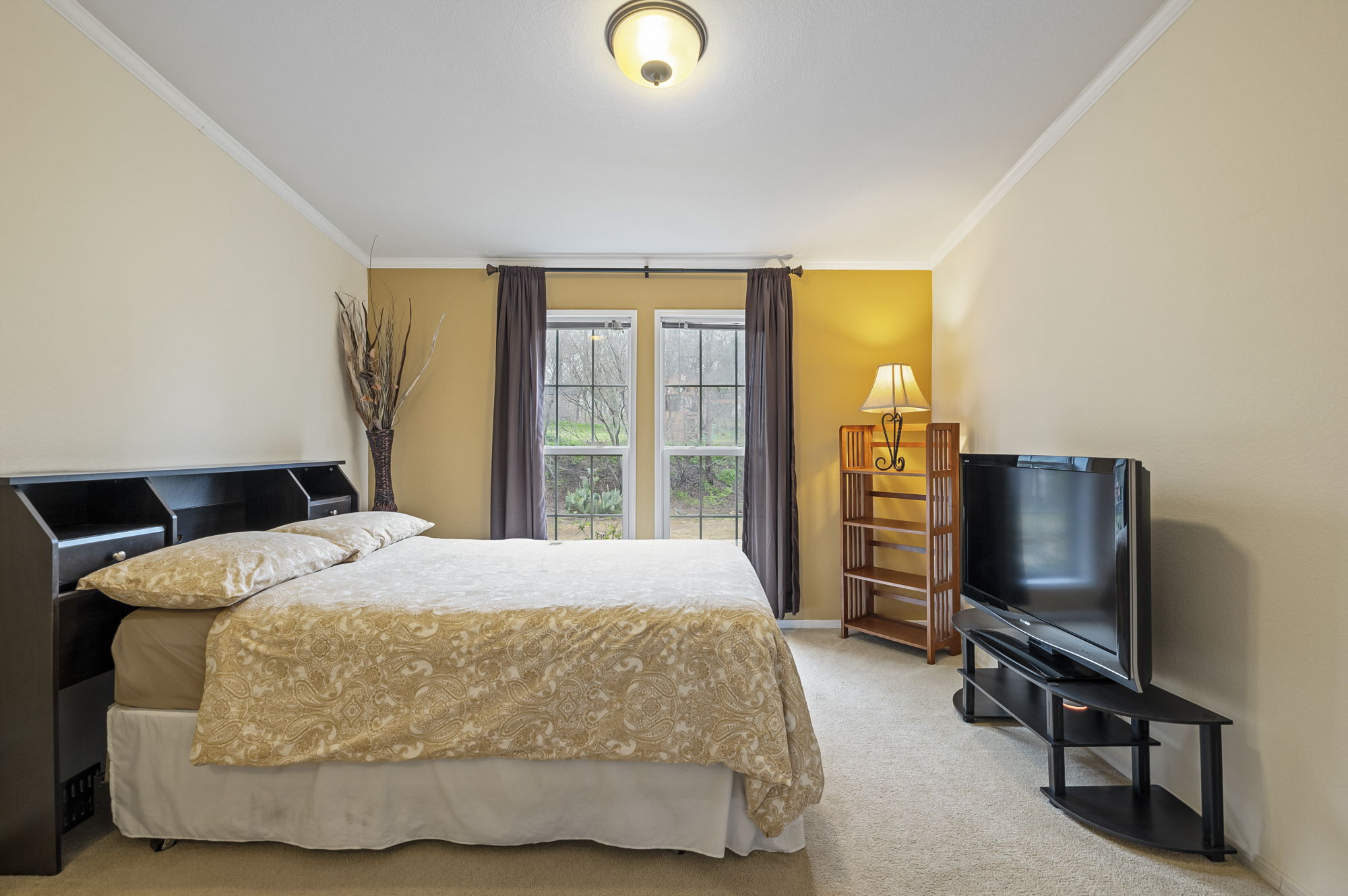 175 Fawn Ridge Road Cedar Creek, TX 78612 - Photo 20 of 34 a bedroom with a bed flat screen tv and a window