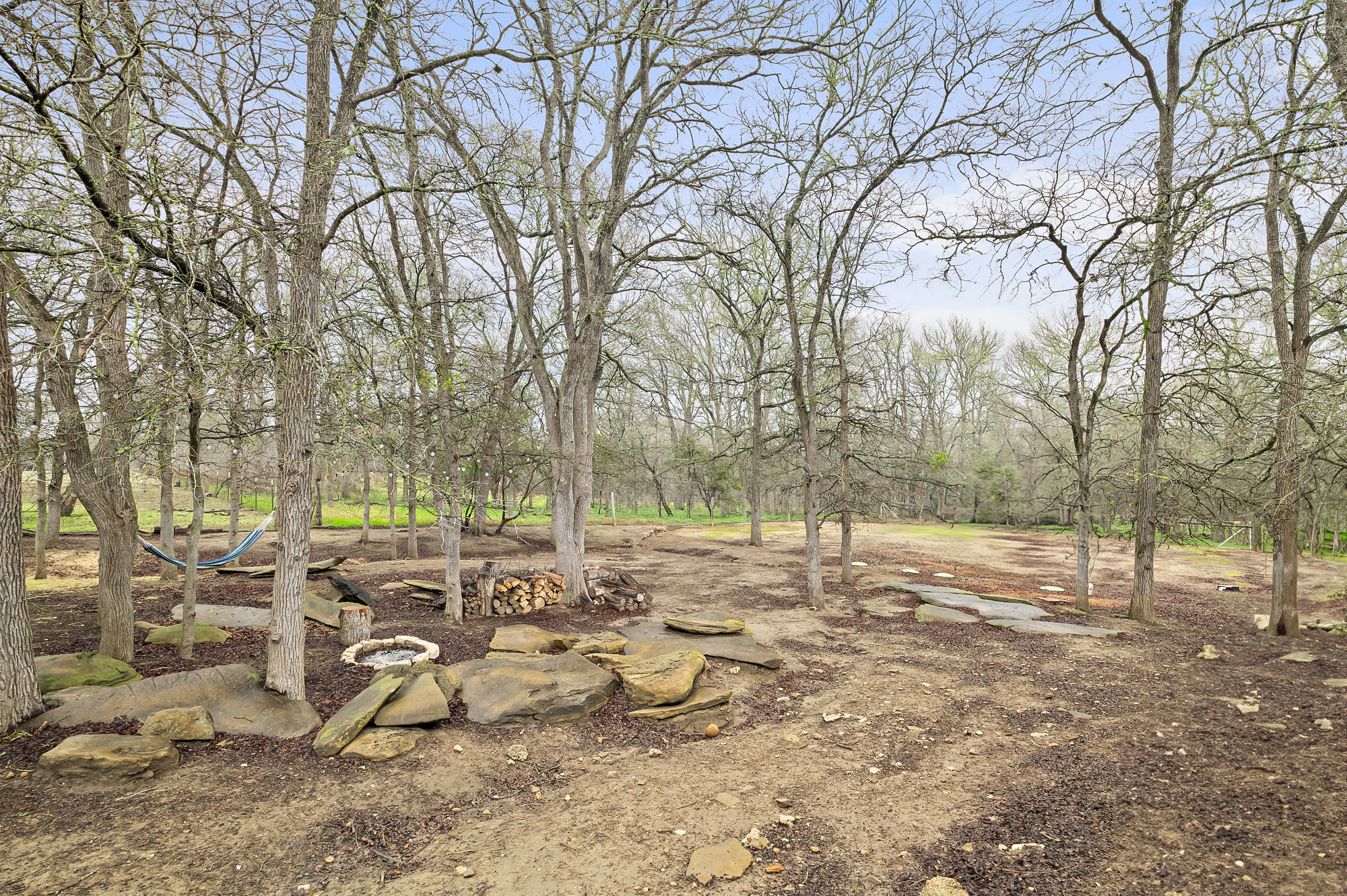 175 Fawn Ridge Road Cedar Creek, TX 78612 - Photo 32 of 34 a view of backyard with large trees and outdoor seating