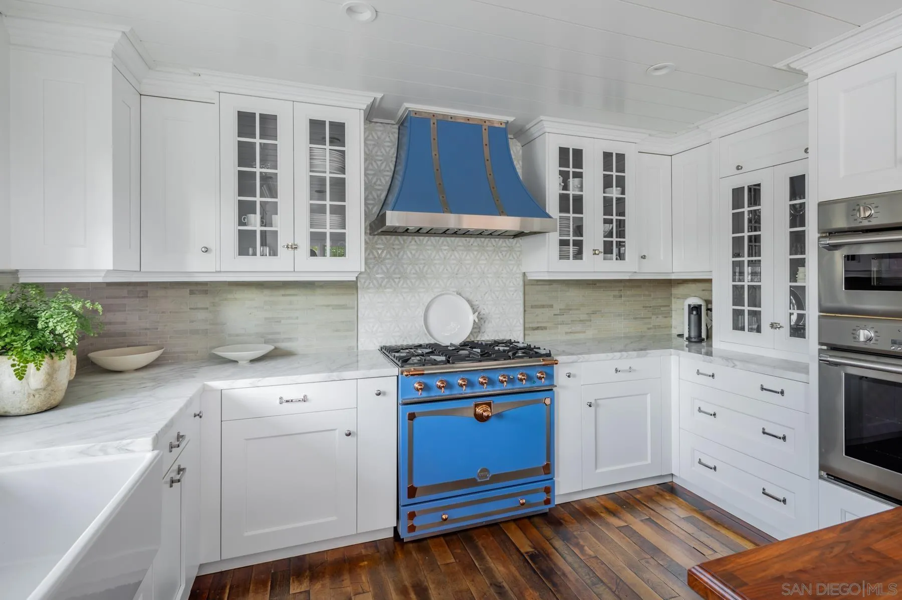 219 27th Street Del Mar, CA 92014 - Photo 19 of 47 a kitchen with stainless steel appliances white cabinets and a stove top oven